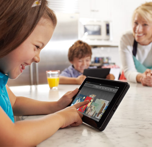 Kindle Fire: young girl using Kindle Fire in the kitchen